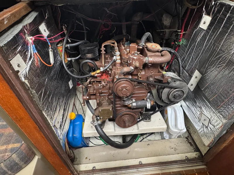 Slide: The Image of Engine compartment of a 1984 O'Day 34 Sloop with visible wiring and components. - 34