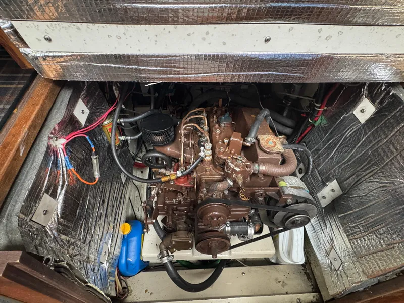 Slide: The Image of Engine compartment of a 1984 O'Day 34 Sloop sailboat, showing detailed wiring and components. - 35