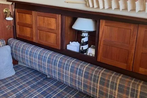 Slide: The Image of Interior of 1984 O'Day 34 Sloop with plaid seating and wooden cabinets. - 4