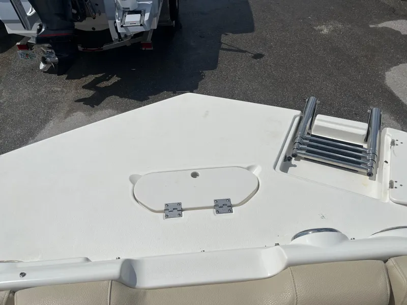 Slide: The Image of 2018 NauticStar 243DC Sport Deck boat with ladder and storage compartment. - 10