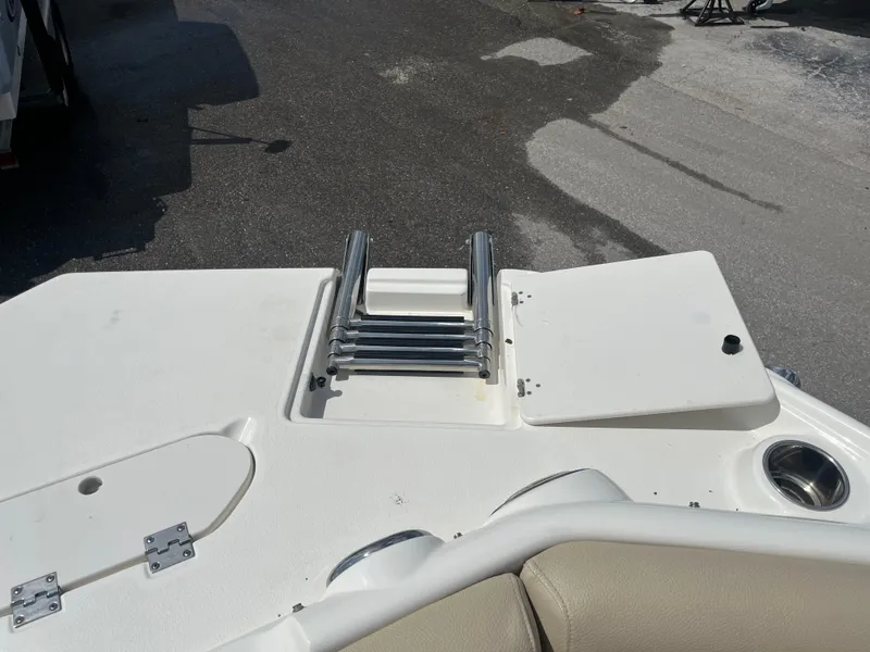 Slide: The Image of 2018 NauticStar 243DC Sport Deck boat with ladder and storage compartment. - 11