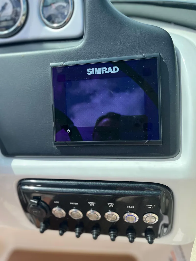 Slide: The Image of Simrad display and control panel on 2018 NauticStar 243DC Sport Deck boat. - 16