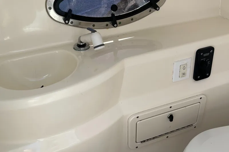 Slide: The Image of Interior of 2018 NauticStar 243DC Sport Deck boat with sink and storage compartment. - 21