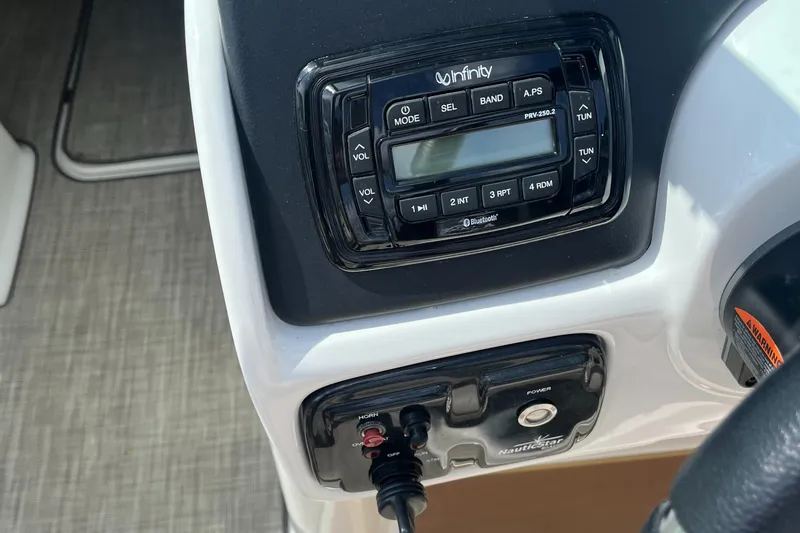 Slide: The Image of Control panel of 2018 NauticStar 243DC Sport Deck boat with Infinity audio system. - 22