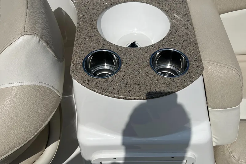 Slide: The Image of 2018 NauticStar 243DC Sport Deck boat interior with cup holders and seating. - 23