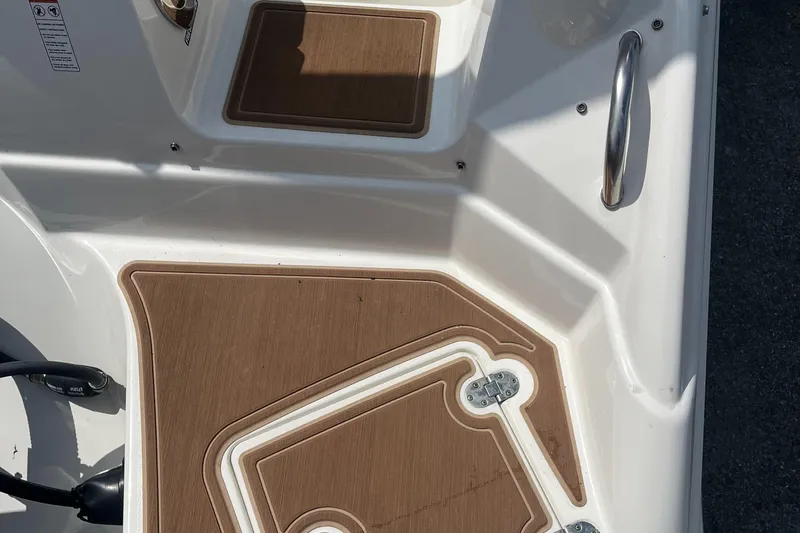 Slide: The Image of 2018 NauticStar 243DC Sport Deck boat interior with brown non-slip flooring. - 25