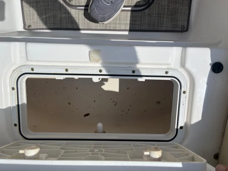 Slide: The Image of Open storage compartment on 2018 NauticStar 243DC Sport Deck boat. - 26
