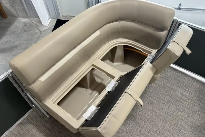 Slide: The Image of 2025 Godfrey Xperience 2086 SBX boat seating with storage compartments open. - 11