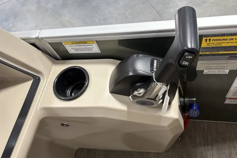 Slide: The Image of Control panel of 2025 Godfrey Xperience 2086 SBX boat with throttle and cup holder. - 21