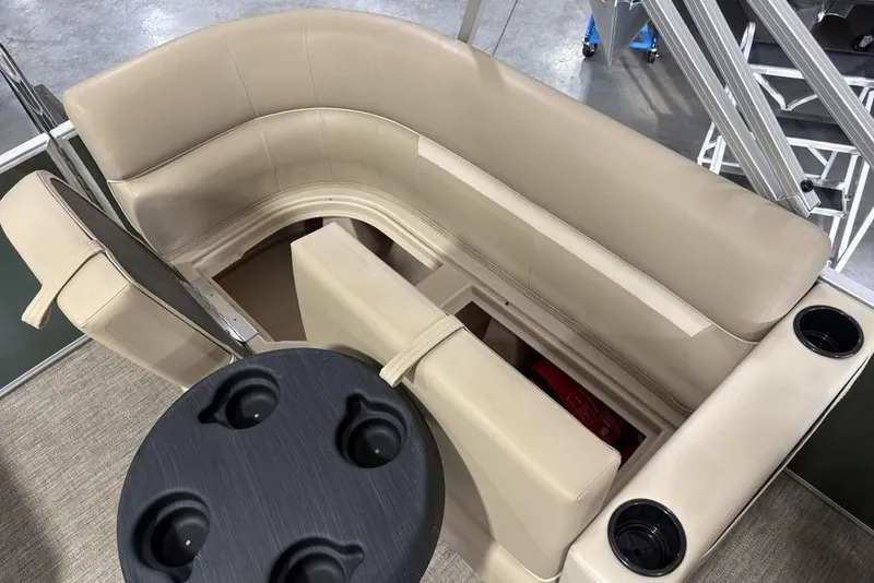 Slide: The Image of 2025 Godfrey Xperience 2086 SBX boat interior with beige seating and cup holders. - 24