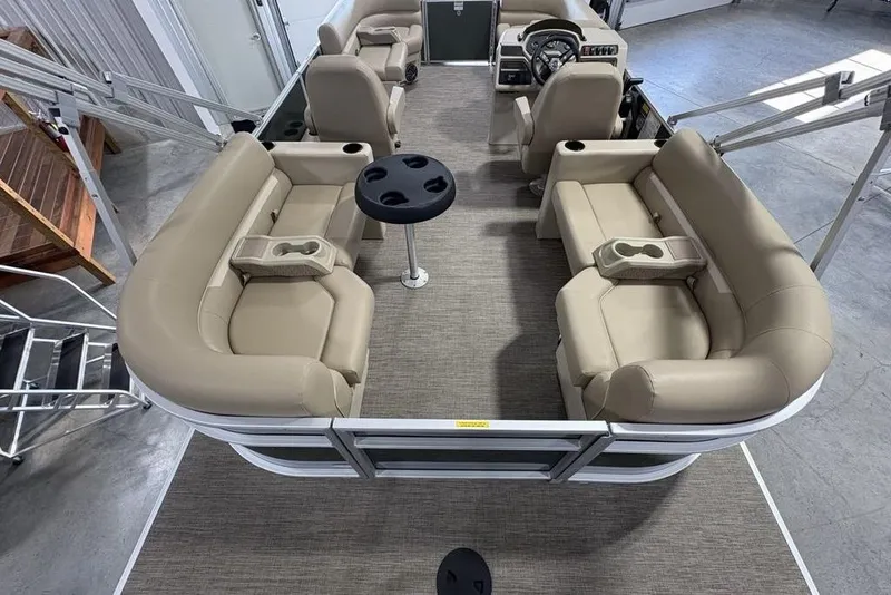 Slide: The Image of 2025 Godfrey Xperience 2086 SBX pontoon boat interior with beige seating and central table. - 30