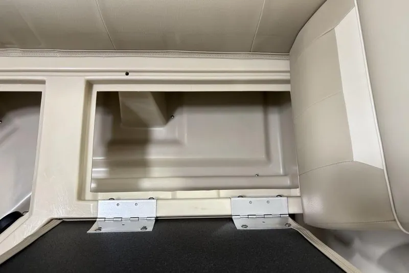 Slide: The Image of Storage compartment in 2025 Godfrey Xperience 2086 SBX boat, featuring beige interior. - 8