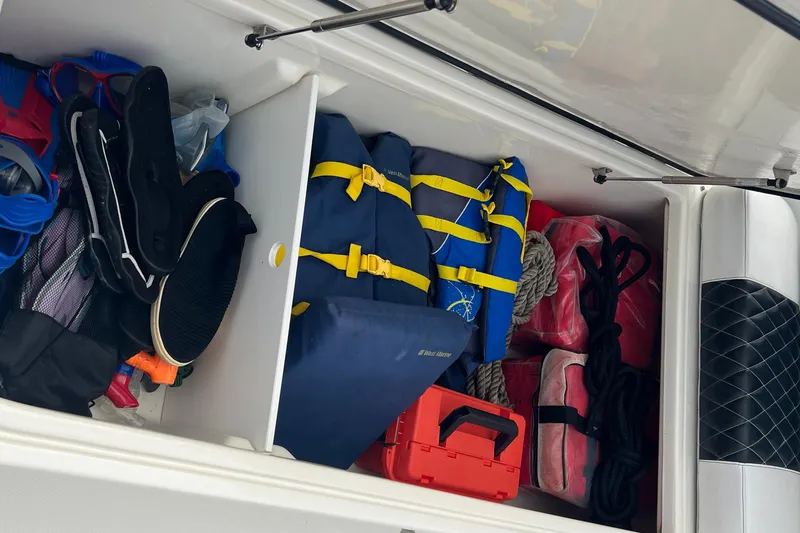 Slide: The Image of Storage compartment of 2003 Hydra-Sports Vector 3300 CC with life jackets and gear. - 10