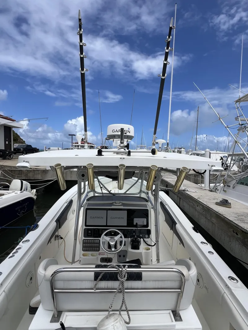 Slide: The Image of 2003 Hydra-Sports Vector 3300 CC boat docked, featuring Garmin electronics and fishing rod holders. - 5