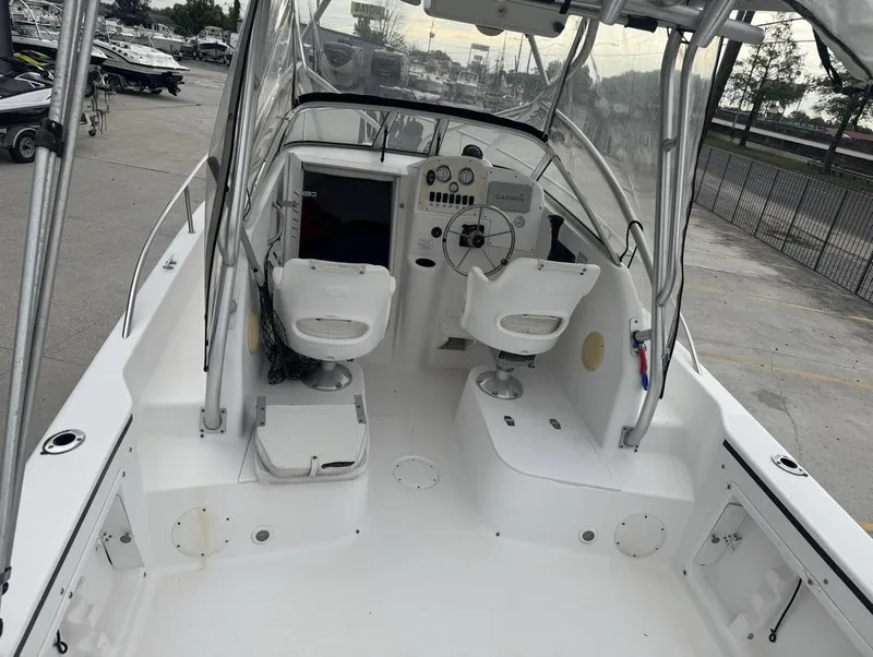 Slide: The Image of 2004 Pro-Line 22 Walk boat interior with steering console and seating. - 12