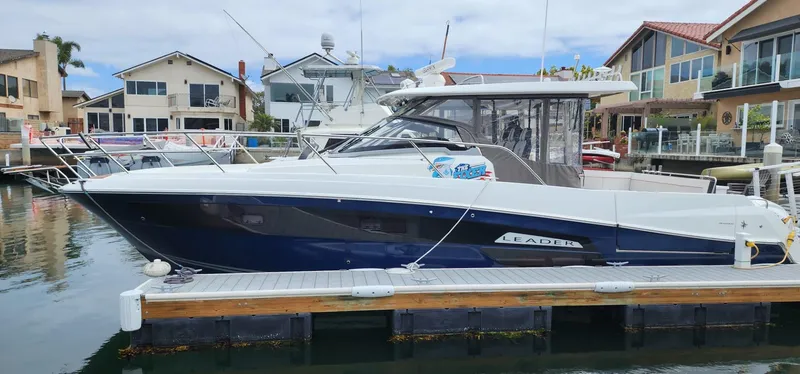The Image of 2022 Jeanneau Leader 12.5 WA boat docked in a residential marina. - 0