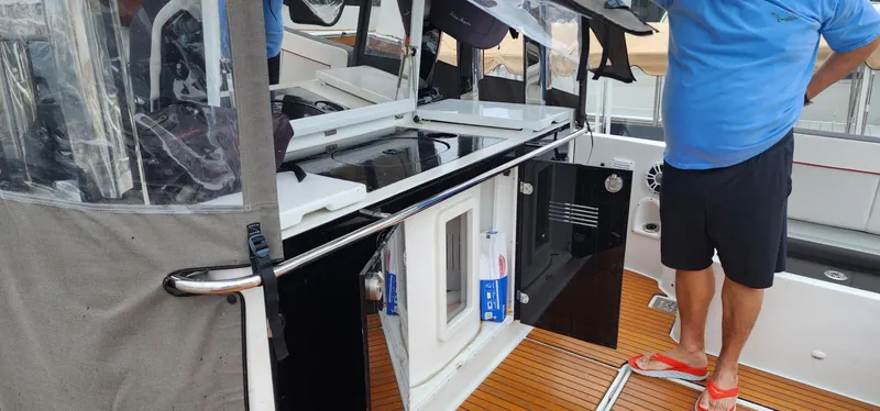 Slide: The Image of 2022 Jeanneau Leader 12.5 WA boat interior with wooden deck and storage compartments. - 14
