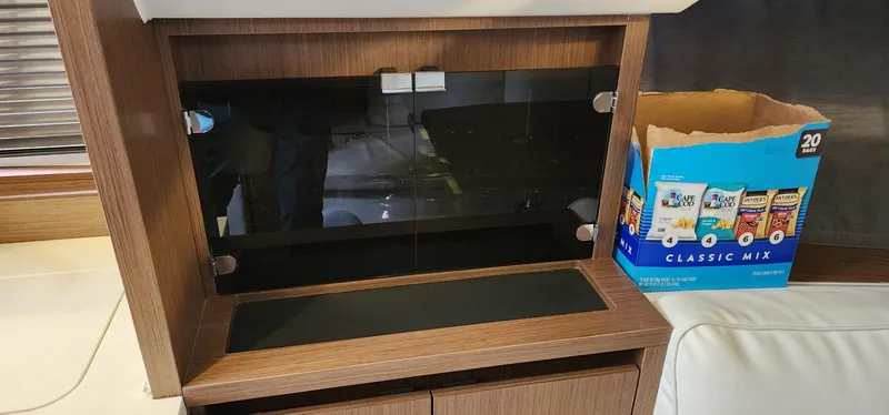 Slide: The Image of Interior of 2022 Jeanneau Leader 12.5 WA with wooden cabinetry and snack box. - 17