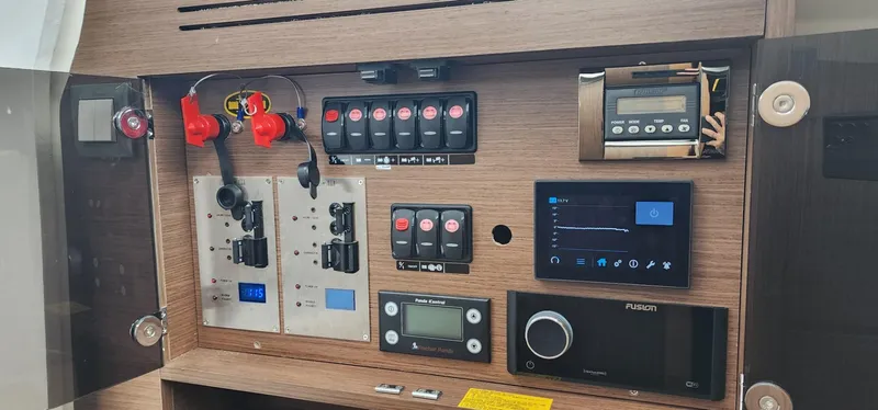 Slide: The Image of Control panel of 2022 Jeanneau Leader 12.5 WA boat with various switches and displays. - 19