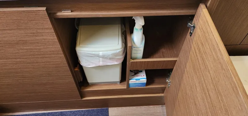 Slide: The Image of Cabinet storage on 2022 Jeanneau Leader 12.5 WA with trash bin and cleaning supplies. - 24