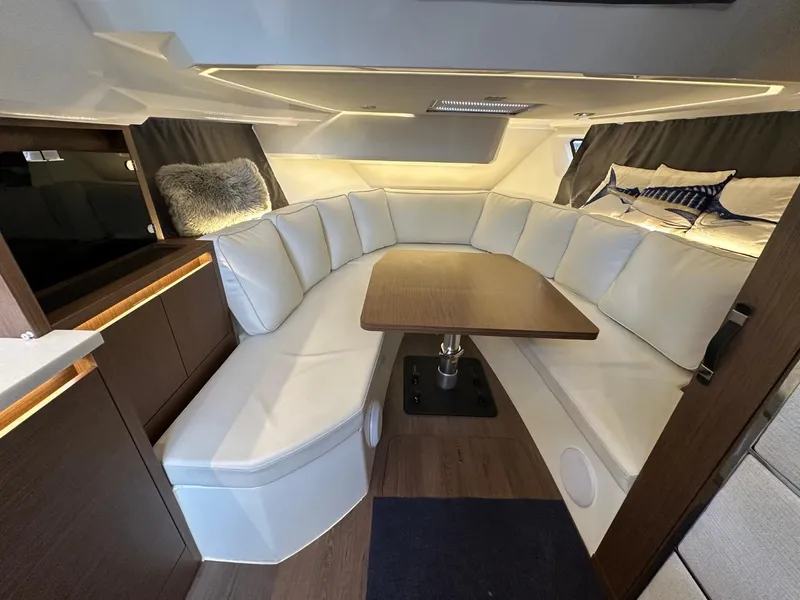 Slide: The Image of Luxurious interior of 2022 Jeanneau Leader 12.5 WA with elegant seating and wooden table. - 29