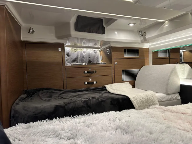 Slide: The Image of Luxurious cabin interior of 2022 Jeanneau Leader 12.5 WA with cozy bedding and modern wood finish. - 33