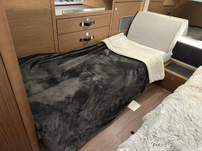 Slide: The Image of Cozy cabin interior of 2022 Jeanneau Leader 12.5 WA with plush bedding and wood cabinetry. - 34