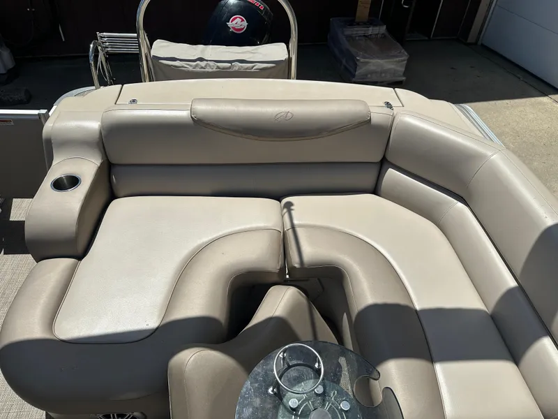 Slide: The Image of 2018 Avalon Catalina Cruise boat interior with beige seating and cup holders. - 13