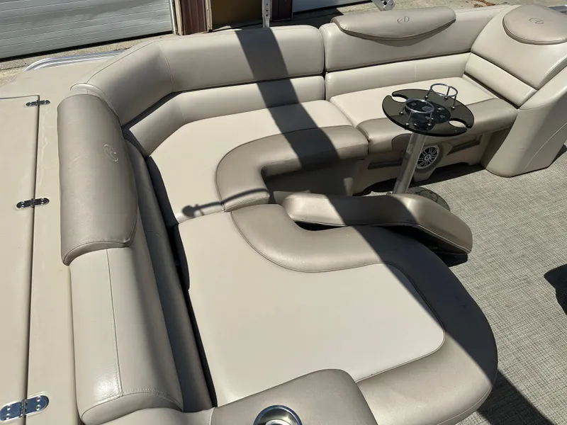 Slide: The Image of Luxurious seating on 2018 Avalon Catalina Cruise 25' boat with beige upholstery and cup holders. - 15