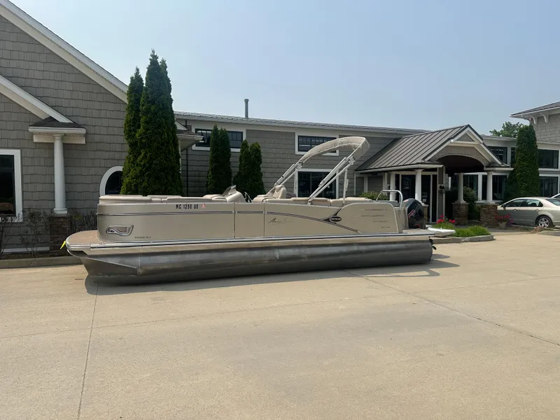 Slide: The Image of 2018 Avalon Catalina Cruise 25' pontoon boat parked outside a building. - 20
