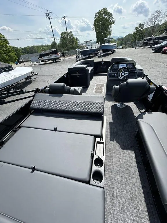Slide: The Image of 2025 Godfrey Sweetwater 2286 SFLC pontoon boat with spacious seating and modern dashboard. - 10