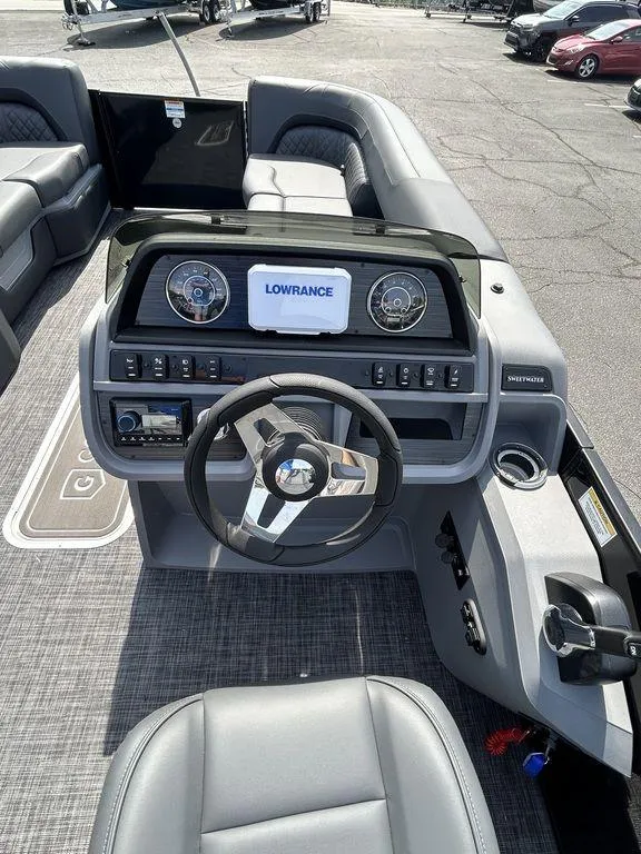 Slide: The Image of 2025 Godfrey Sweetwater 2286 SFLC boat dashboard with steering wheel and Lowrance display. - 11