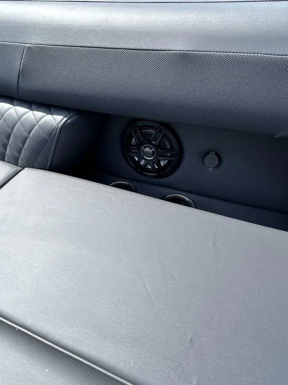 Slide: The Image of 2025 Godfrey Sweetwater 2286 SFLC boat interior with speaker and cushioned seating. - 17