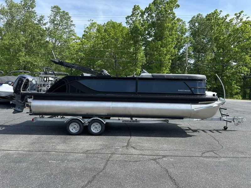 Slide: The Image of 2025 Godfrey Sweetwater 2286 SFLC pontoon boat on trailer, parked outdoors. - 3