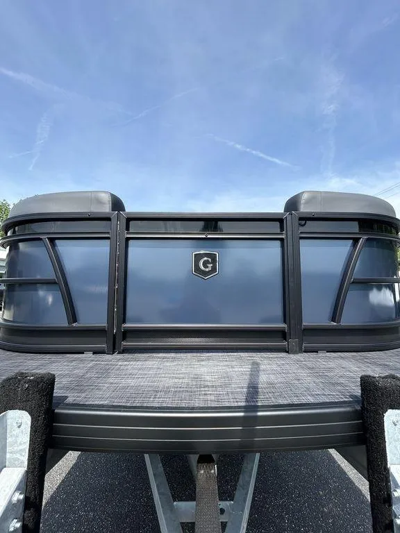 Slide: The Image of 2025 Godfrey Sweetwater 2286 SFLC pontoon boat, front view under clear blue sky. - 4