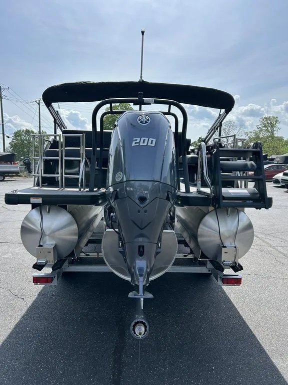 Slide: The Image of 2025 Godfrey Sweetwater 2286 SFLC pontoon boat with powerful 200 HP engine, rear view. - 5