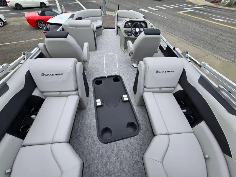 Slide: The Image of 2025 Berkshire 22 RFX LE pontoon boat interior with gray seating and central table. - 15