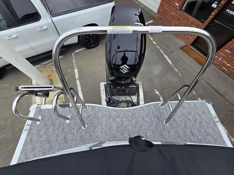 Slide: The Image of 2025 Berkshire 22 RFX LE boat with Suzuki outboard motor, viewed from above in a parking lot. - 16