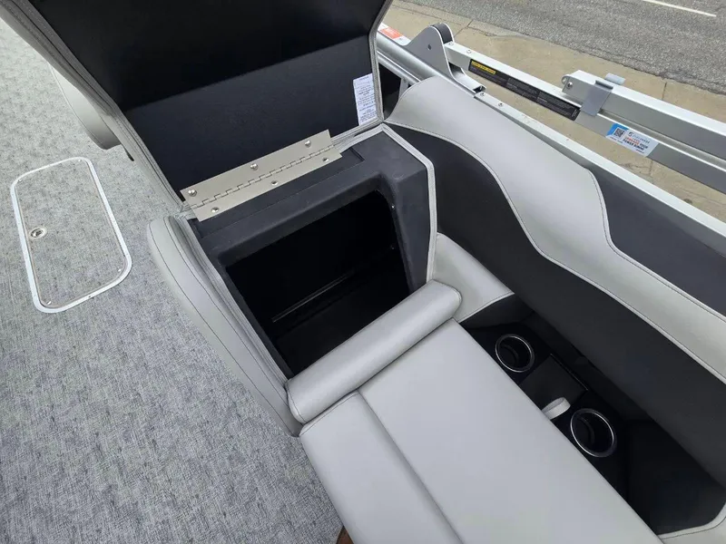 Slide: The Image of 2025 Berkshire 22 RFX LE boat interior with open storage compartment and cup holders. - 18