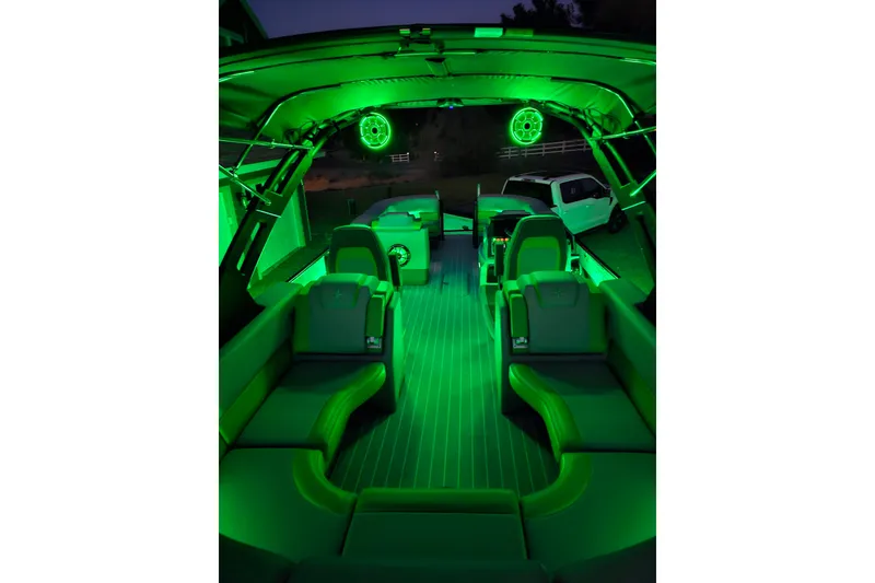 Slide: The Image of 2025 Berkshire 22 RFX LE boat interior with vibrant green LED lighting. - 28