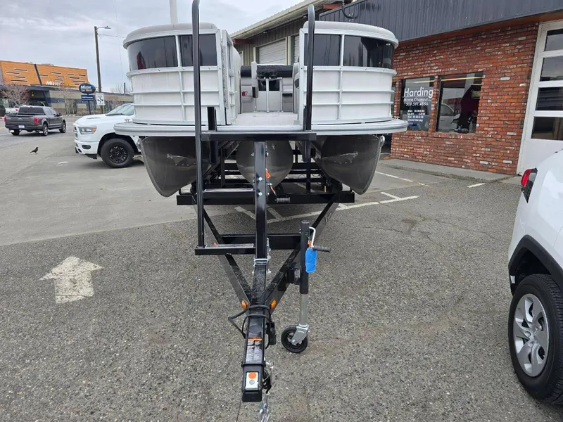 Slide: The Image of 2025 Berkshire 22 RFX LE pontoon boat on trailer in parking lot. - 3