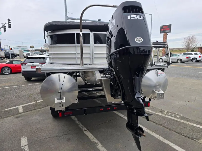 Slide: The Image of 2025 Berkshire 22 RFX LE pontoon boat with 150 HP engine on a trailer. - 4