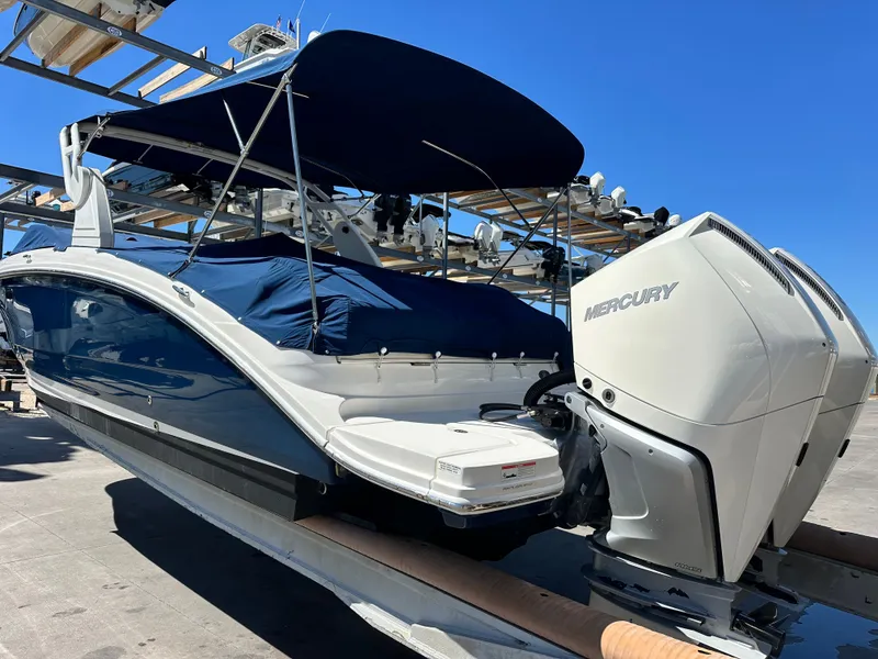 Slide: The Image of 2019 Sea Ray SDX 290 Outboard with Mercury engines, docked under a clear blue sky. - 21