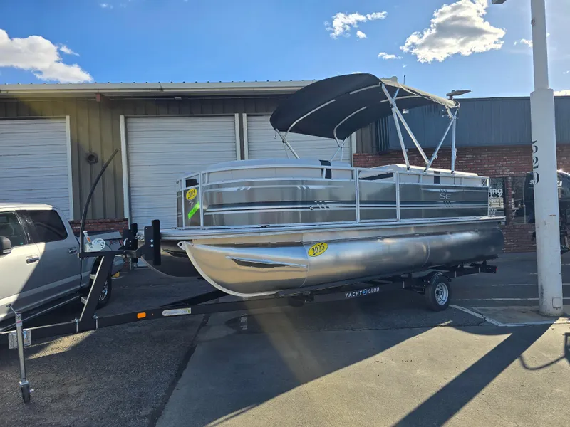 The Image of 2025 Berkshire 20 CL pontoon boat on trailer, parked outdoors under a clear sky. - 0
