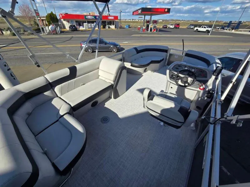 Slide: The Image of 2025 Berkshire 20 CL pontoon boat interior with plush seating and modern dashboard. - 7