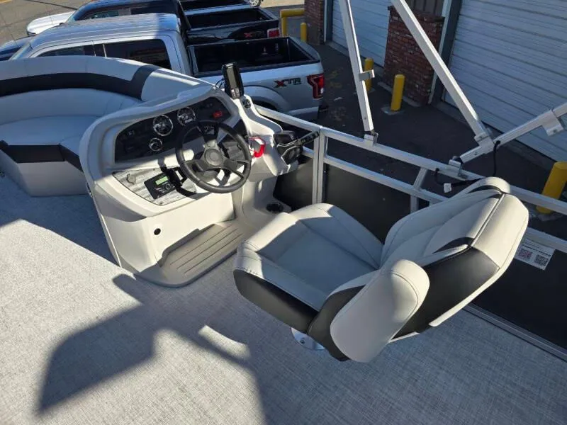 Slide: The Image of 2025 Berkshire 20 CL boat interior with steering wheel and captain's chair. - 8