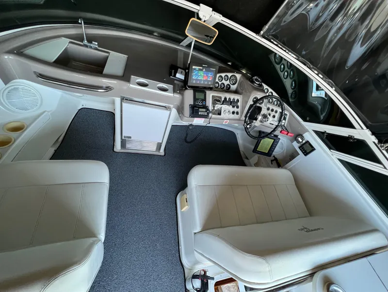 Slide: The Image of 1997 Carver 350 Mariner cockpit with dual seats, control panel, and navigation equipment. - 14