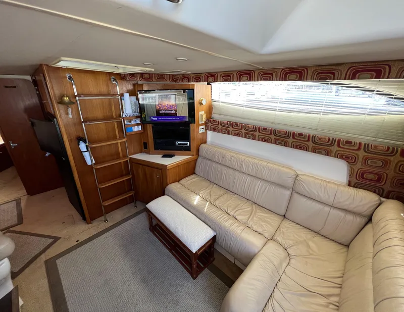 Slide: The Image of 1997 Carver 350 Mariner interior with beige leather seating and entertainment center. - 19