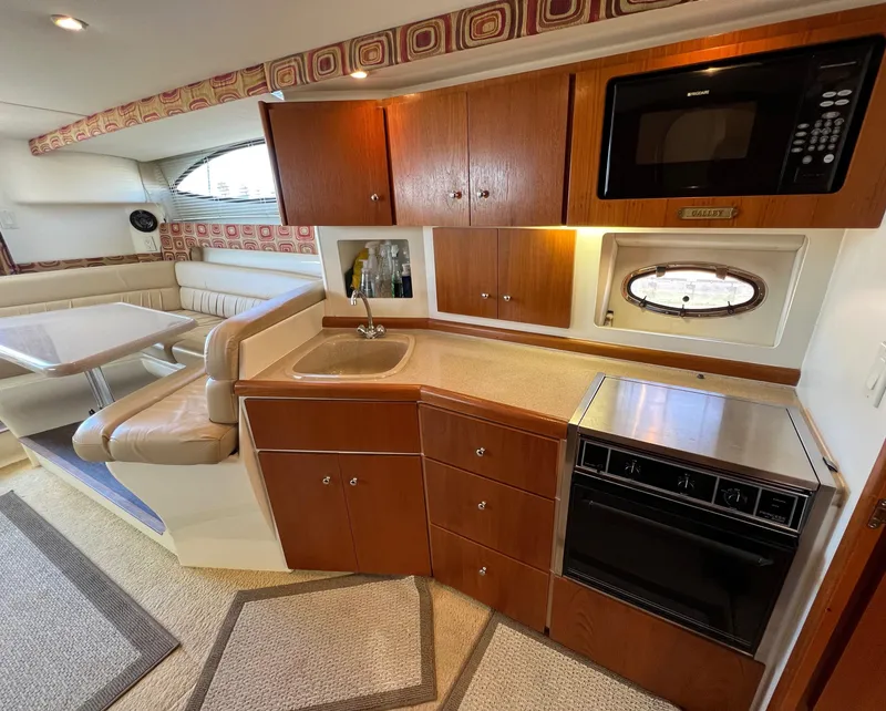 Slide: The Image of Interior of 1997 Carver 350 Mariner yacht with kitchen and dining area. - 23
