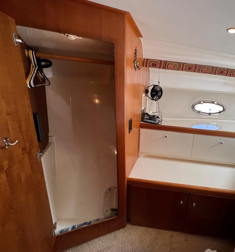 Slide: The Image of 1997 Carver 350 Mariner interior with wooden closet and porthole window. - 27